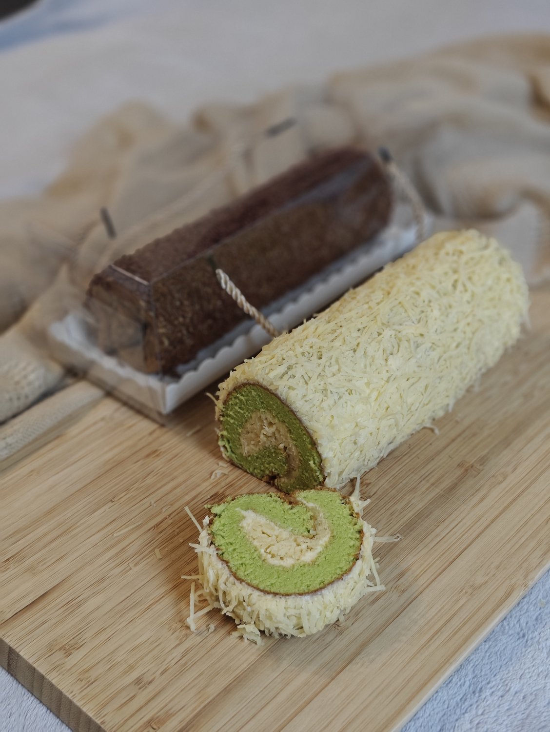 Swiss roll cakes in chocolate and matcha showing swirling interior